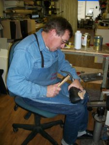Erhard Marenbach manifacturing a custom made shoe